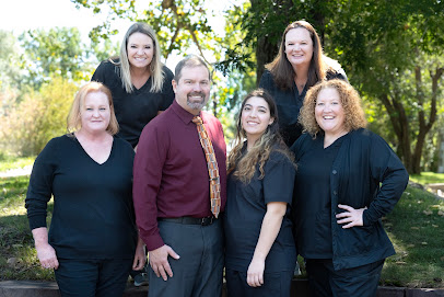 Group photo of the five person Gunbarrel Family Dentistry team standing together outdoors