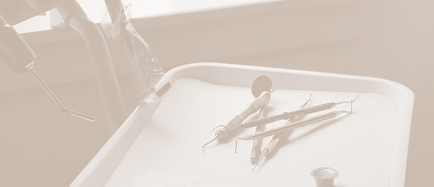 Sterilized dental mirror and explorers arranged on a clean instrument tray
